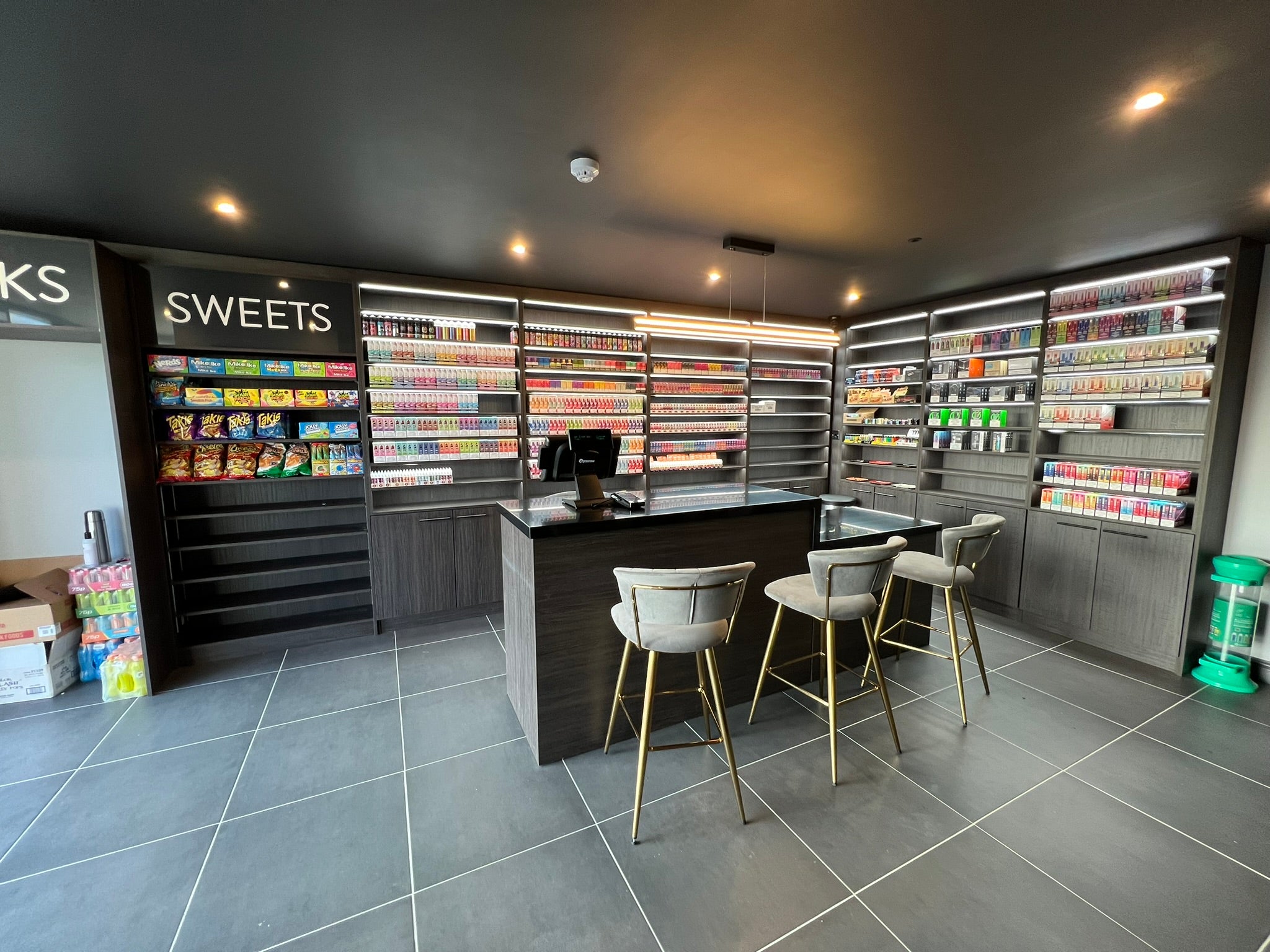 Completed VapeWay Lounge interior with bespoke illuminated display cabinetry, storage and solid-surface retail counter.