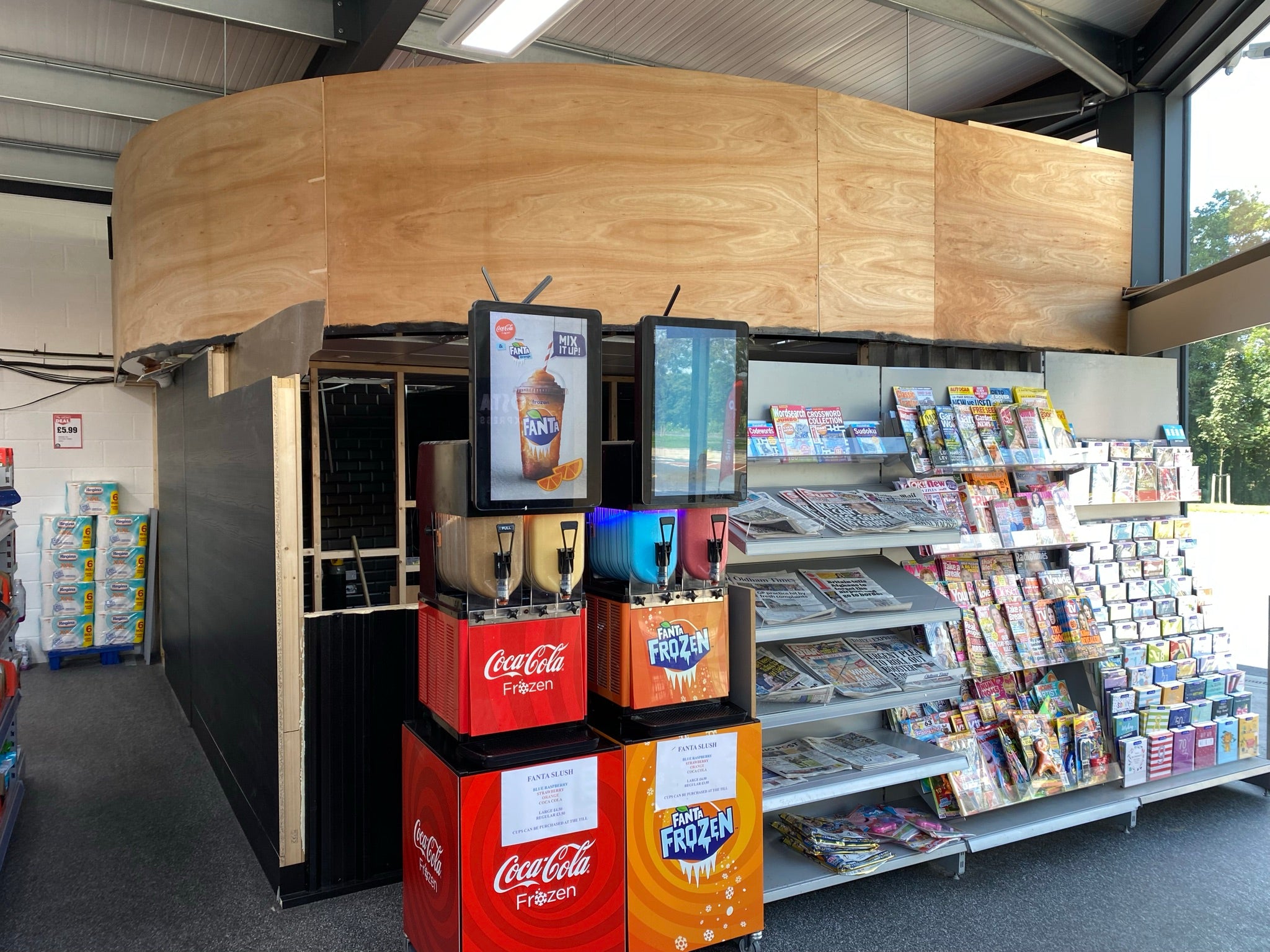Unfinished curved plywood fascia inside a petrol station before the installation of Smashville Burger Co. signage.