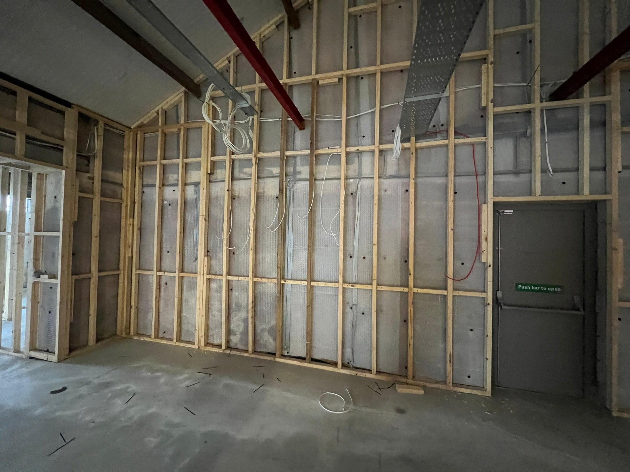 Unfinished YOH Burger customer area with exposed timber framing, steel roof supports and electrical cabling.