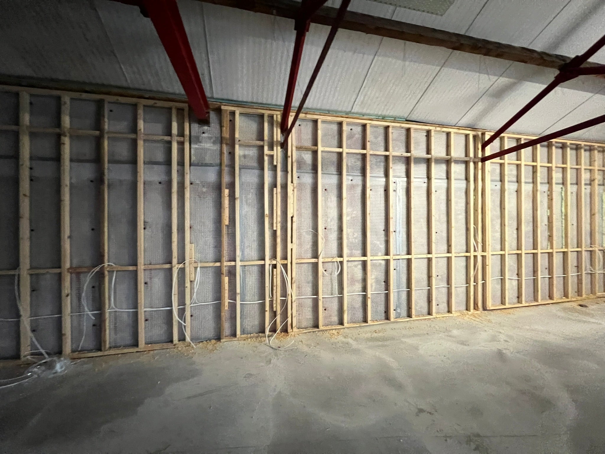 Empty restaurant interior with exposed timber framing and electrical cabling before the YOH Burger fit-out.