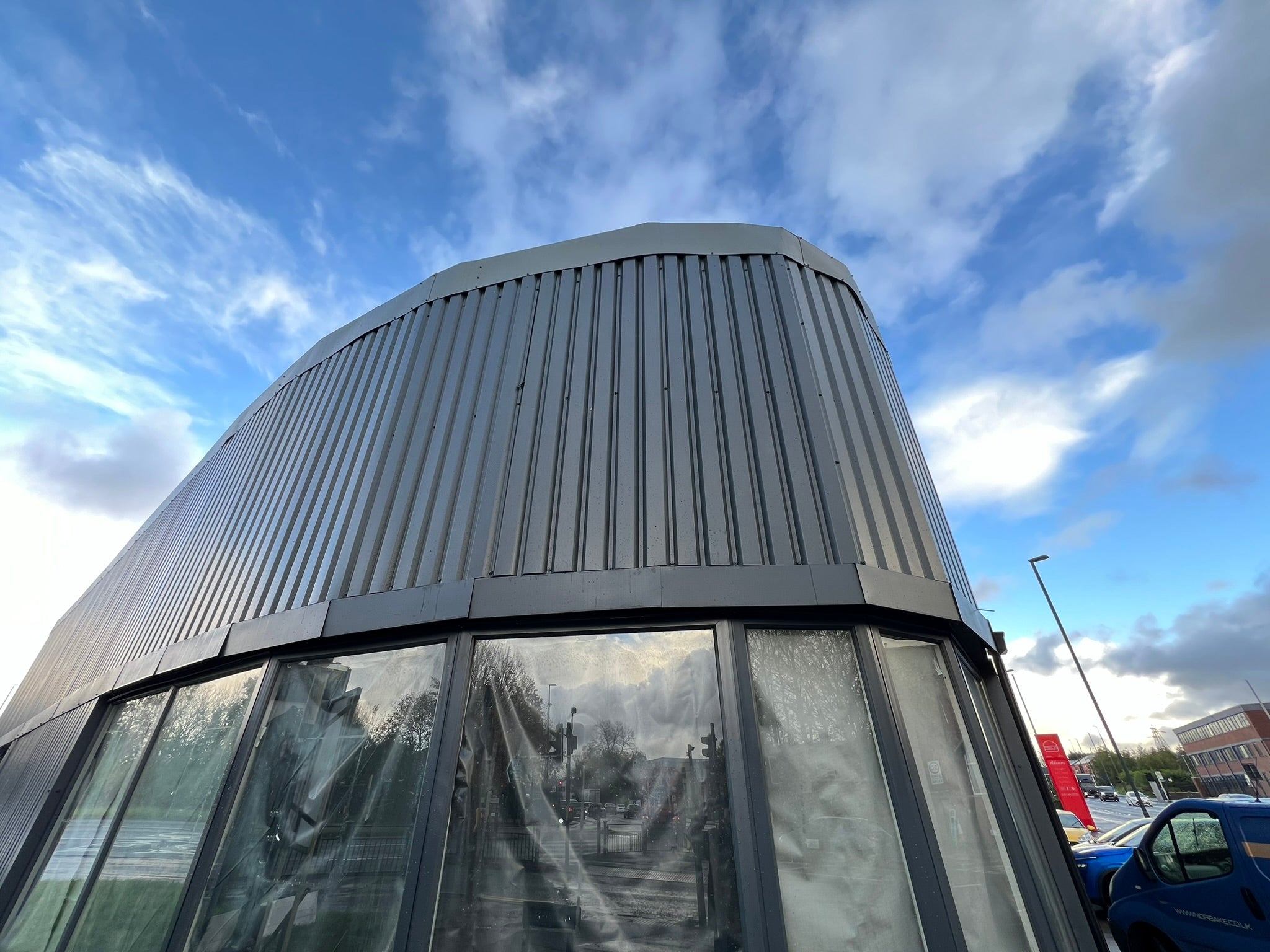 Unbranded curved frontage of the empty commercial unit before the YOH Burger fit-out and signage installation.
