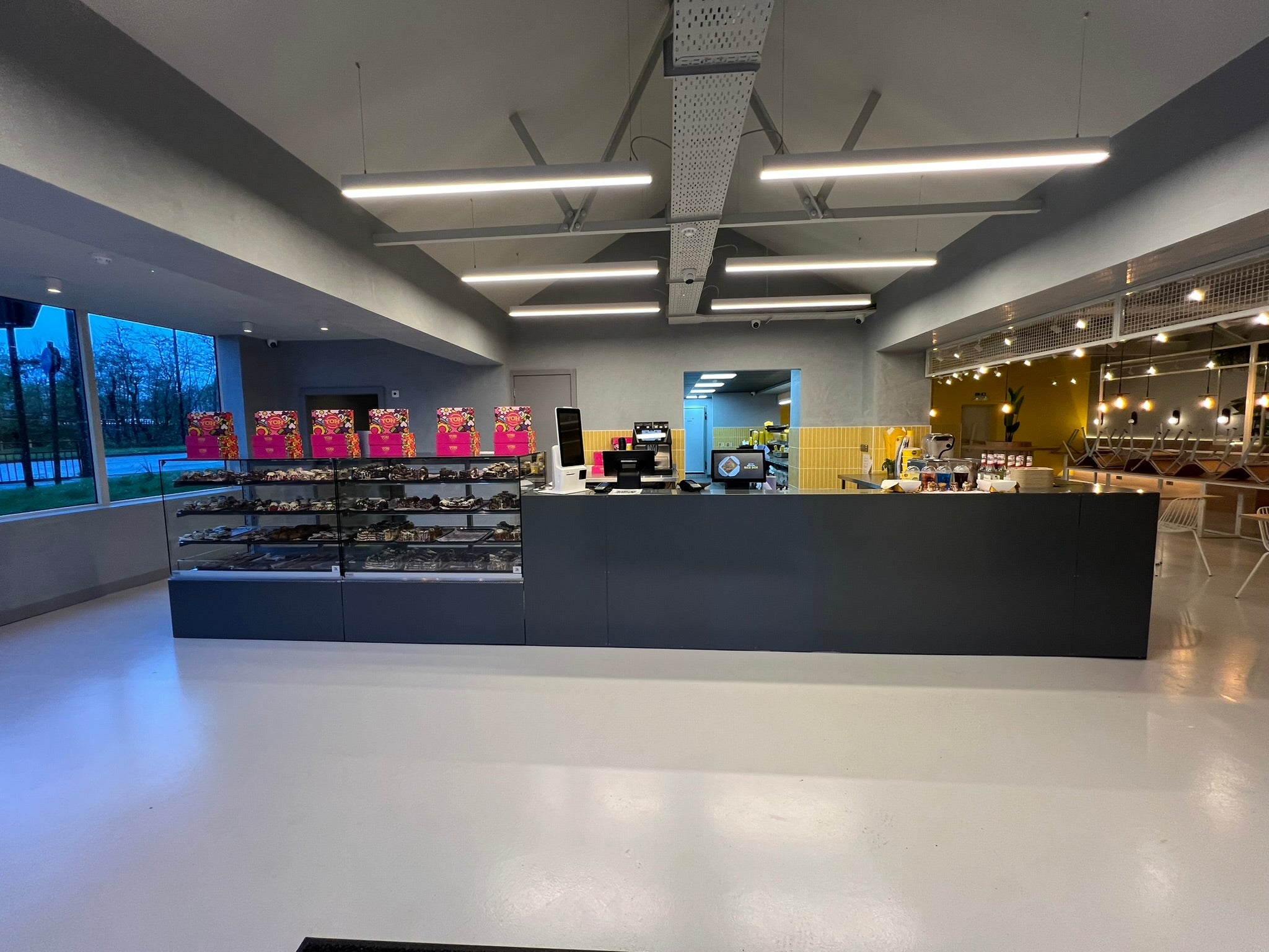 Completed YOH Burger restaurant with a bespoke service counter, chilled display and modern interior lighting.